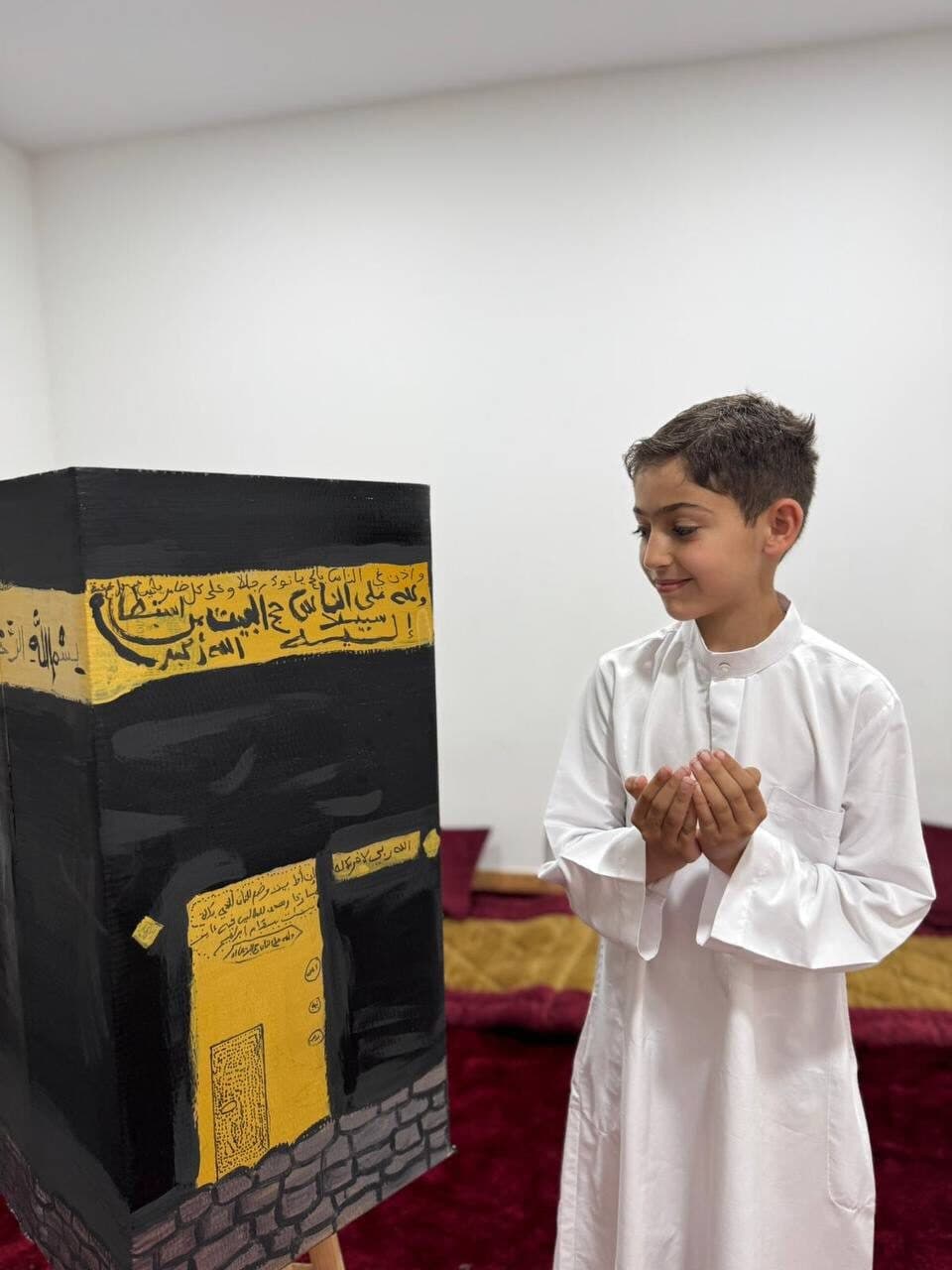 Student beside Hajj display