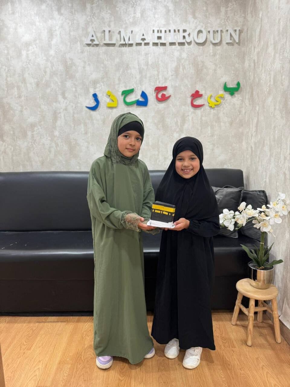 Students holding handmade Kaaba models