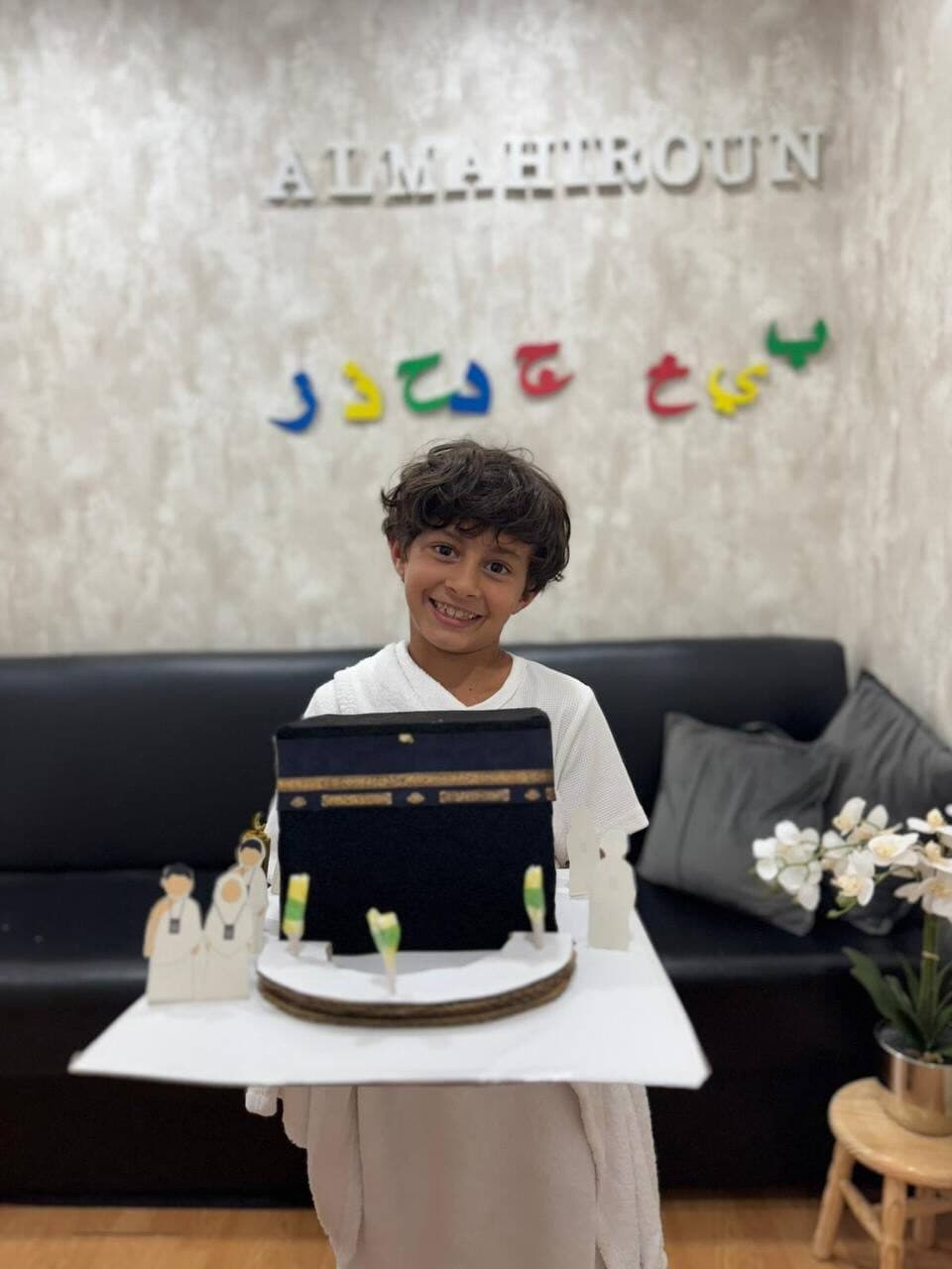 Student holding Kaaba model